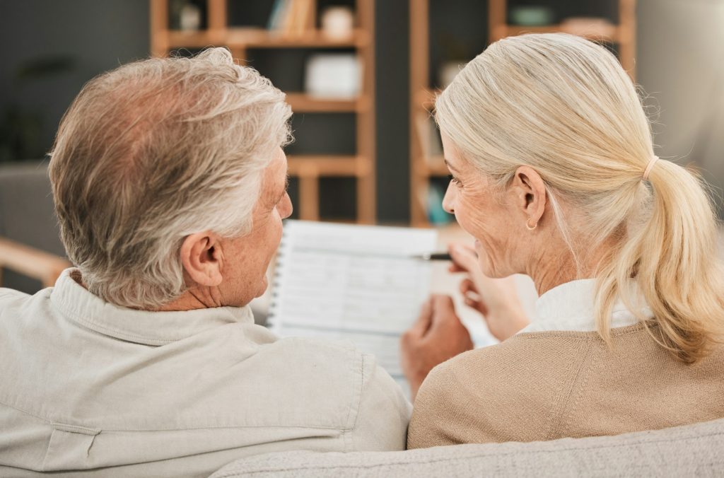 Old couple with life insurance application, retirement fund and paperwork, partner with property in