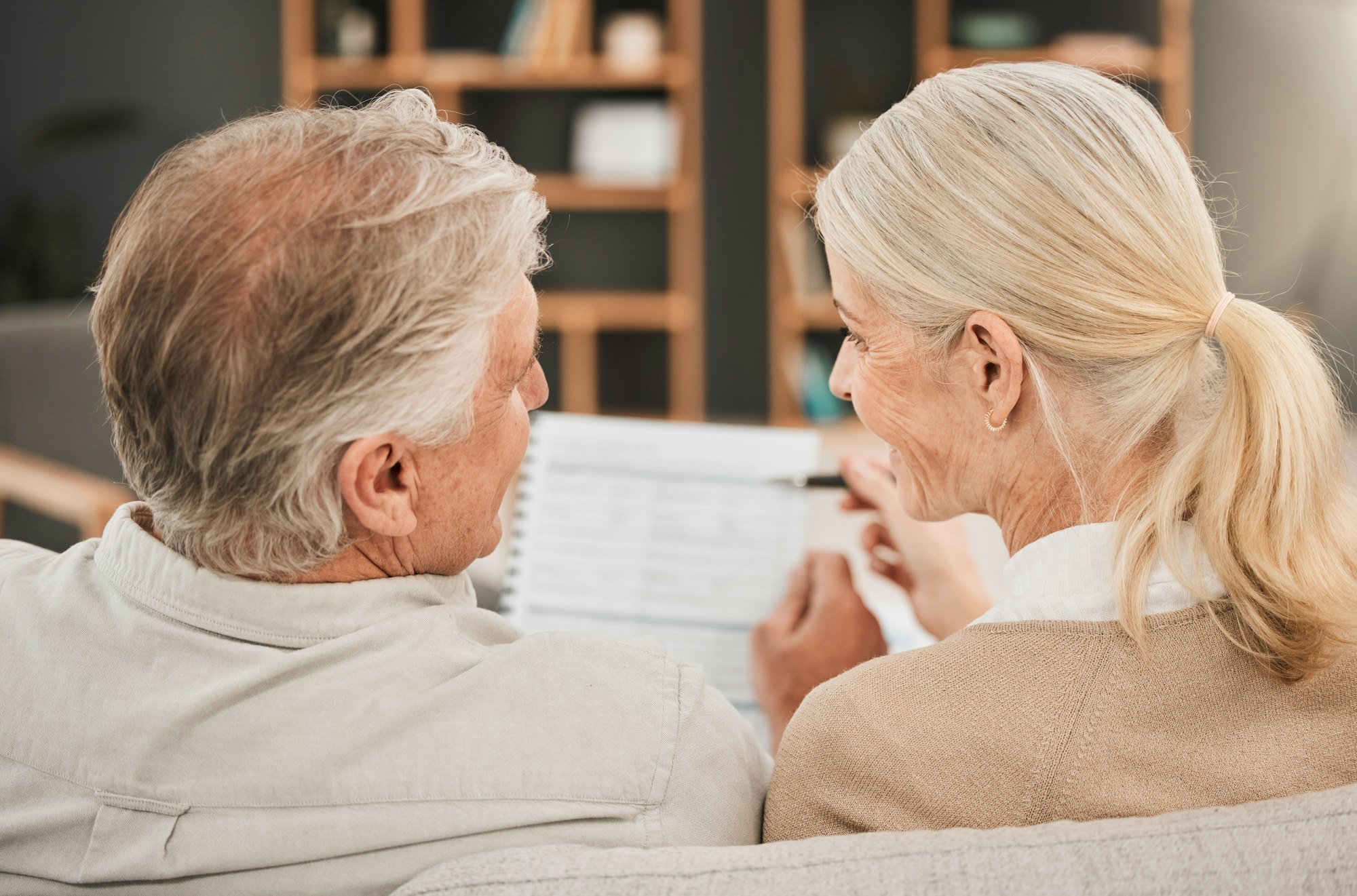 Old couple with life insurance application, retirement fund and paperwork, partner with property in